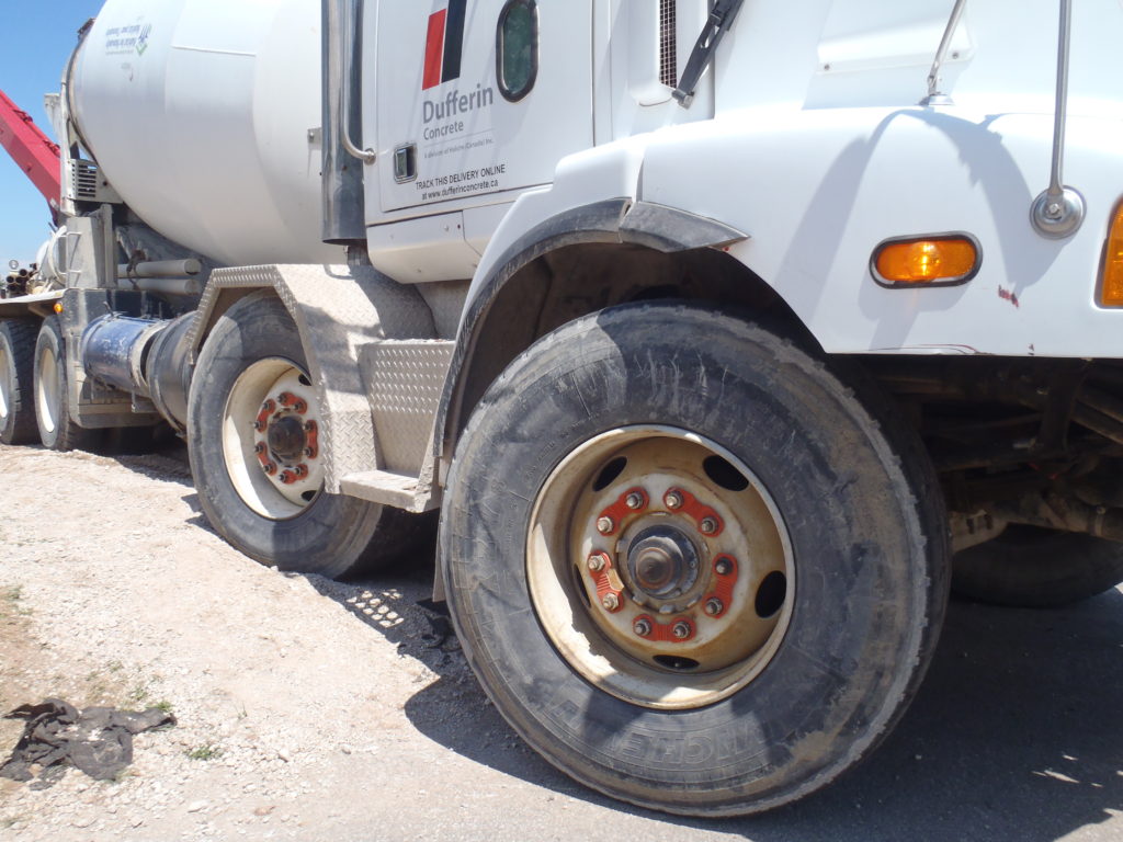Close-up commercial truck wheel with retained nuts