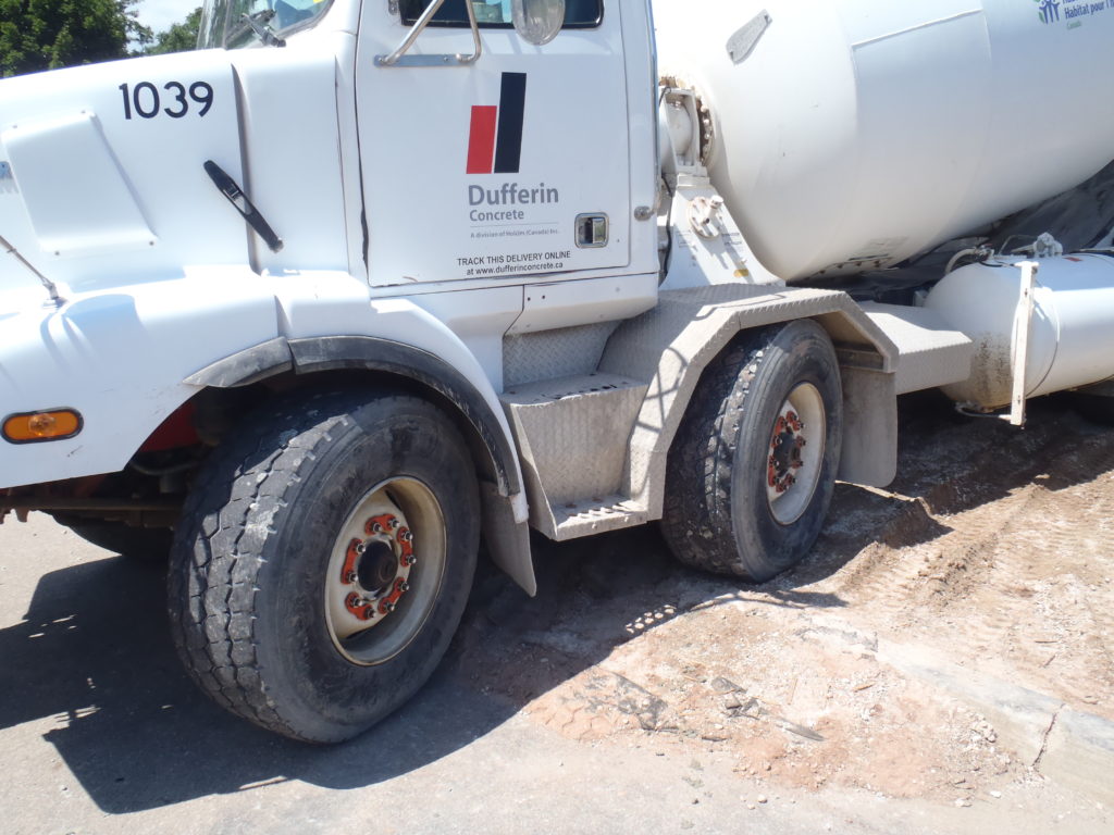 Close-up commercial truck wheel with retained nuts