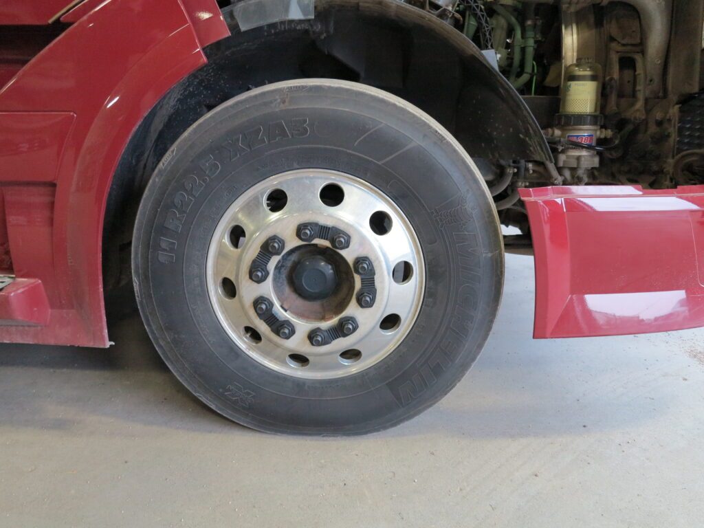 Close-up commercial truck wheel with retained nuts